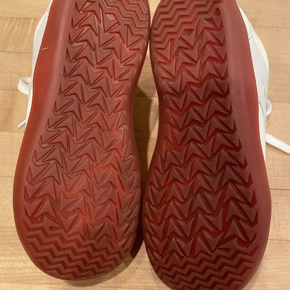 White Sneakers reddish brown soles.